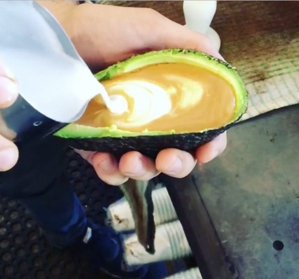 An Avolatte, a latte poured into a hollowed out avocado half