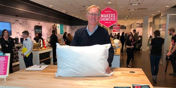 A maker showcasing a product at a Brookstone store display