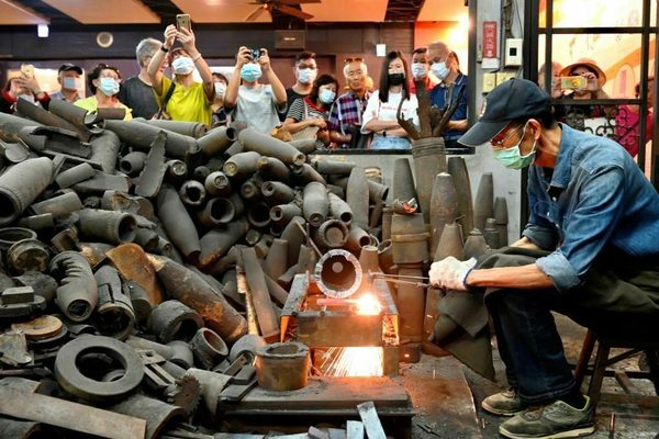 A blacksmith forging a knife from bomb metal
