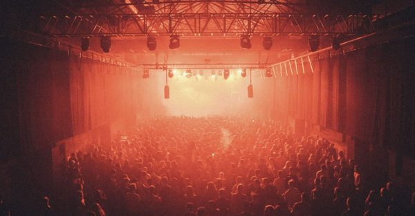 Dancers on a nightclub dancefloor under club lights