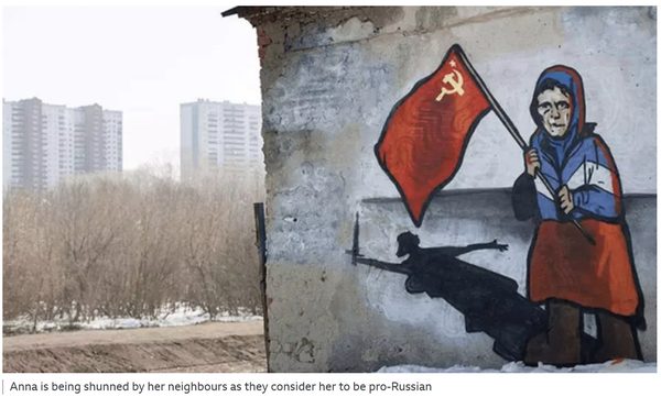 Elderly Ukrainian woman known as Babushka Z holding a red Soviet flag