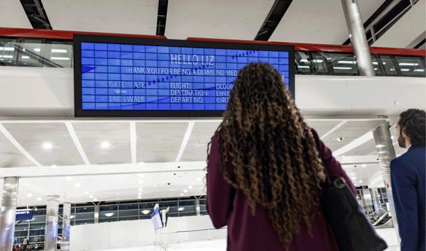 Airport flight information board showing personalized details for a passenger