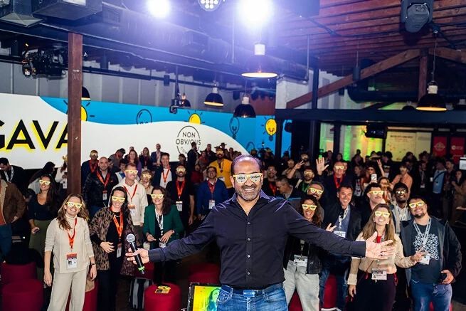 Rohit on stage with his arms open to the audience